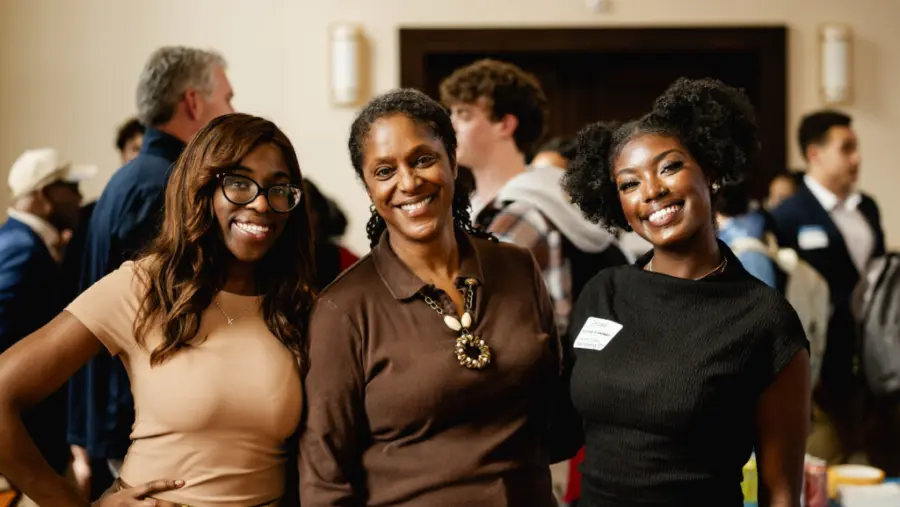 Women posing for the camera at event